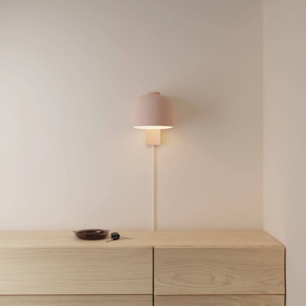 The coral Gio Wall Light from Gantri in a primary bedroom.
