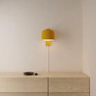 The mustard Gio Wall Light from Gantri in a primary bedroom.