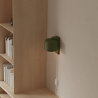The olive Gio Wall Light from Gantri in a home office.