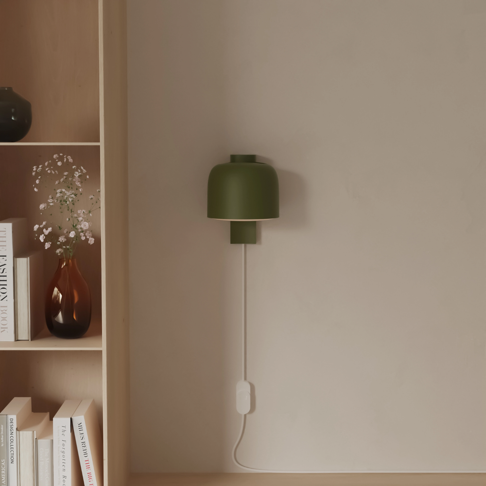 The olive Gio Wall Light from Gantri in a living room.
