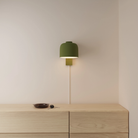 The olive Gio Wall Light from Gantri in a primary bedroom.