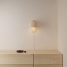 The peach Gio Wall Light from Gantri in a primary bedroom.