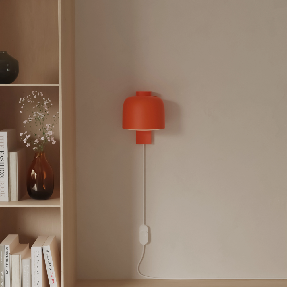 The persimmon Gio Wall Light from Gantri in a living room.