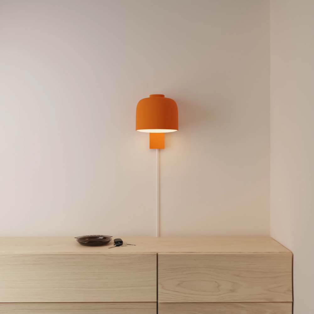 The persimmon Gio Wall Light from Gantri in a primary bedroom.