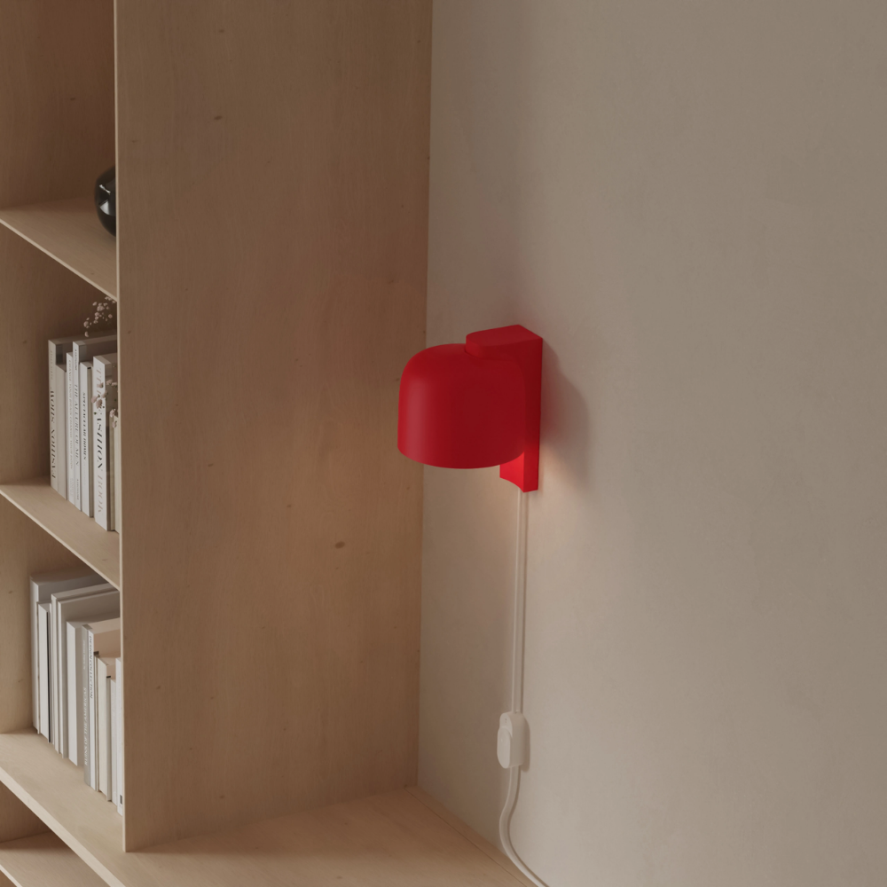 The poppy Gio Wall Light from Gantri in a home office.
