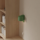 The sage Gio Wall Light from Gantri in a home office.