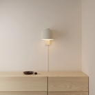 The sand Gio Wall Light from Gantri in a primary bedroom.