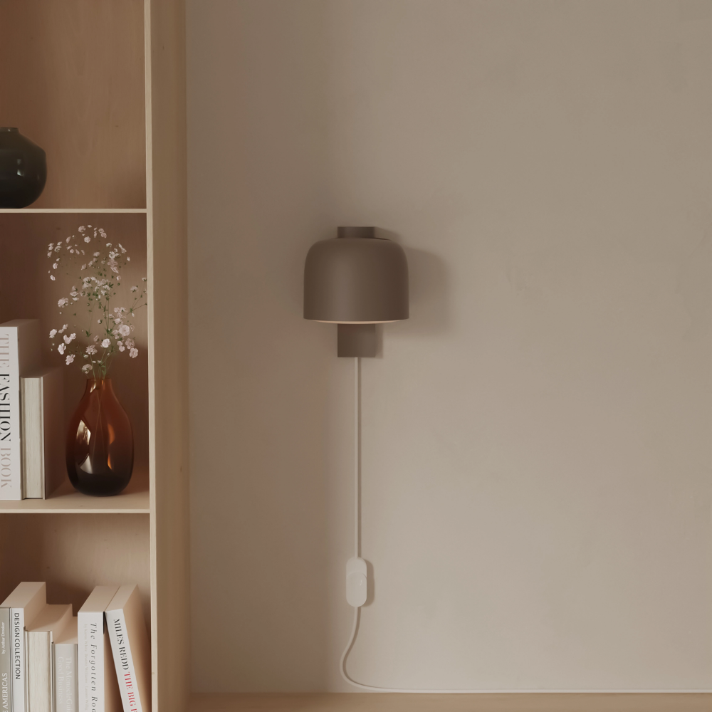 The smoke Gio Wall Light from Gantri in a living room.