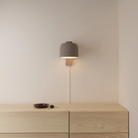 The smoke Gio Wall Light from Gantri in a primary bedroom.