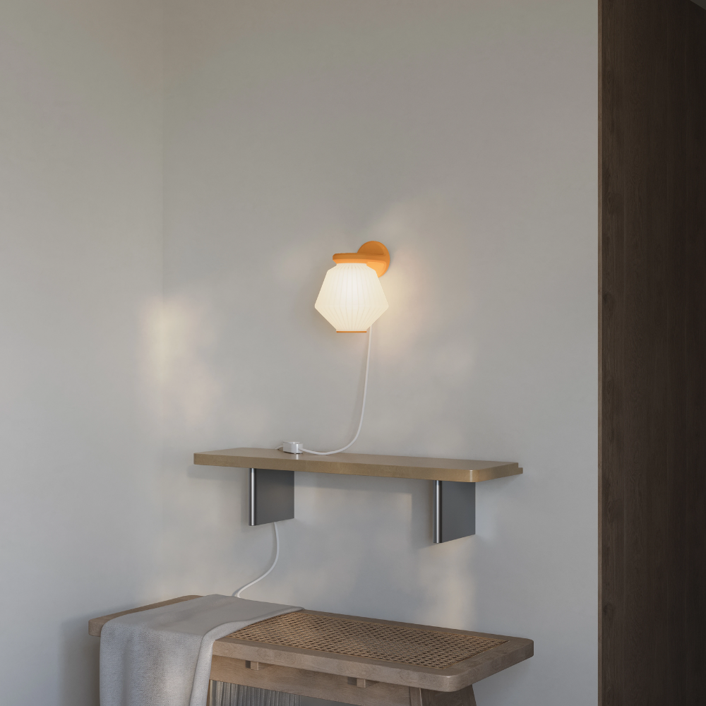 The persimmon Granada Wall Light from Gantri in a living room.