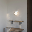 The snow Granada Wall Light from Gantri ln a living room.