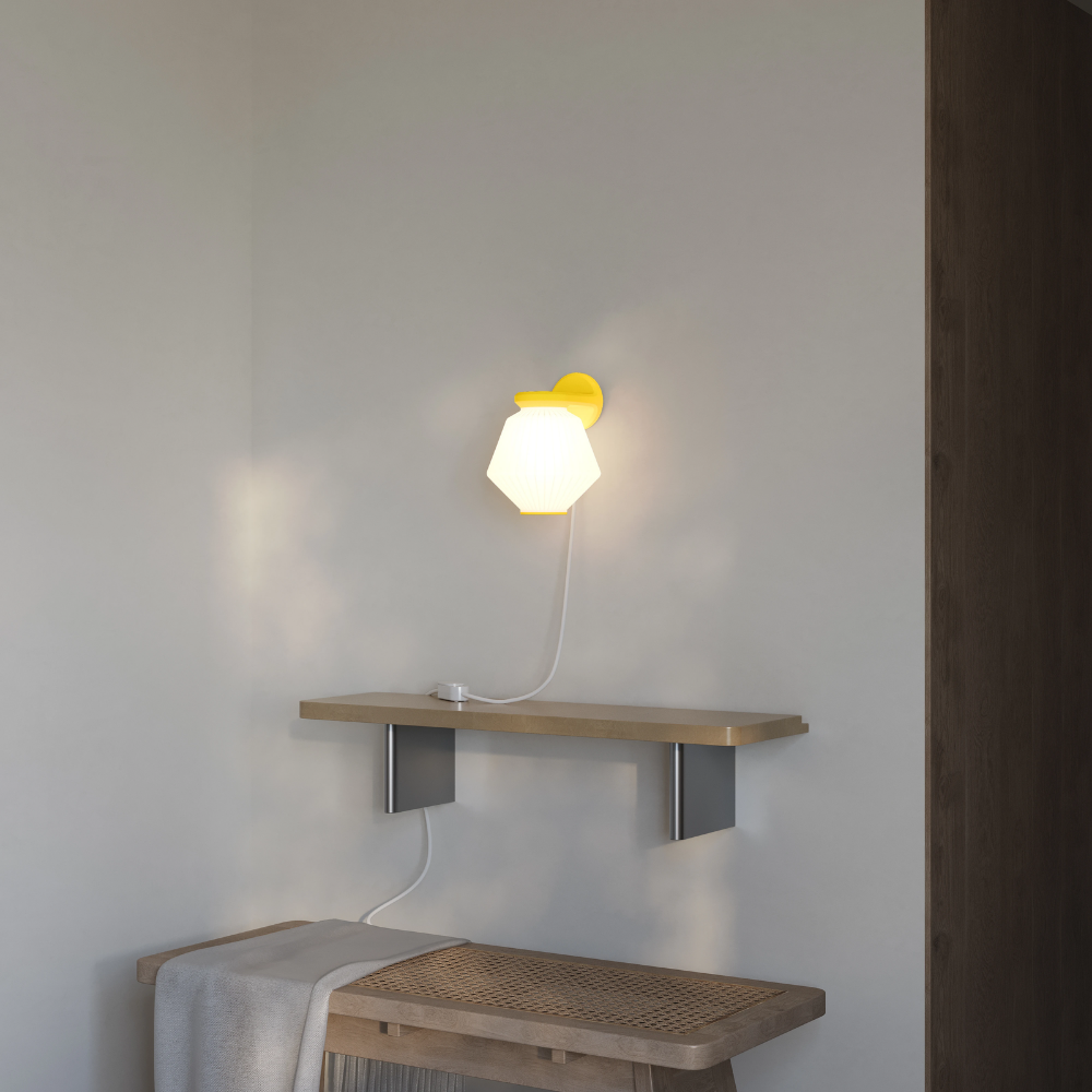 The sunrise Granada Wall Light from Gantri in a living room.