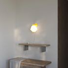 The sunrise Granada Wall Light from Gantri in a living room.