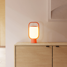 The persimmon Kero Table Light from Gantri in a family area.