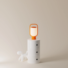 The persimmon Kero Table Light from Gantri in a home office.