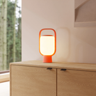 The persimmon Kero Table Light from Gantri in a living room.
