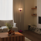 The hibiscus Kobble Floor Light from Gantri with the chrome rod option in a family area near a fireplace.