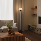 The midnight Kobble Floor Light from Gantri with the white rod option in a lounge space next to a sofa.