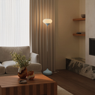 The sky Kobble Floor Light from Gantri with the chrome rod option in a family area near a fireplace.
