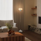 The snow Kobble Floor Light from Gantri with the chrome rod option in a family area near a fireplace.