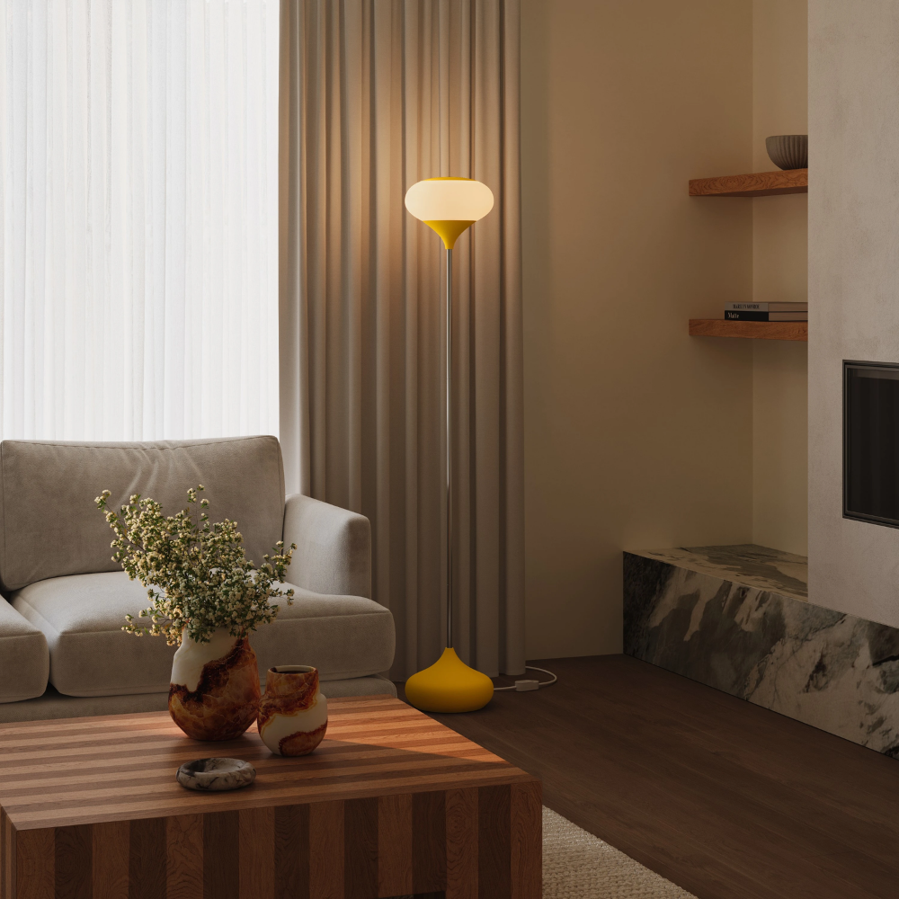 The sunrise Kobble Floor Light from Gantri with the chrome rod option in a family area near a fireplace.