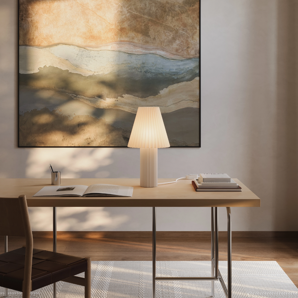 The Pleat Table Light from Gantri in a home office on top of a desk.