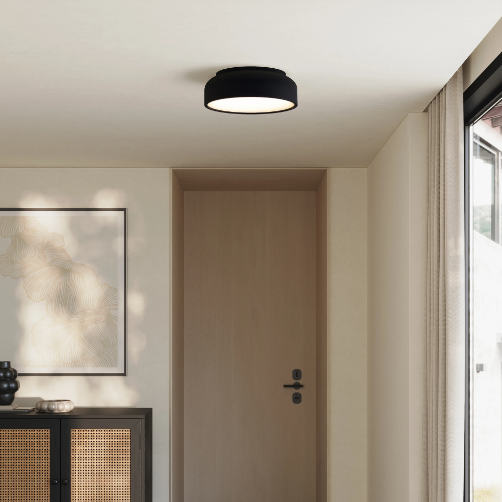 The carbon Vitria Flush Mount from Gantri in a living room on the ceiling.
