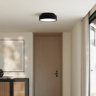 The carbon Vitria Flush Mount from Gantri in a living room on the ceiling.