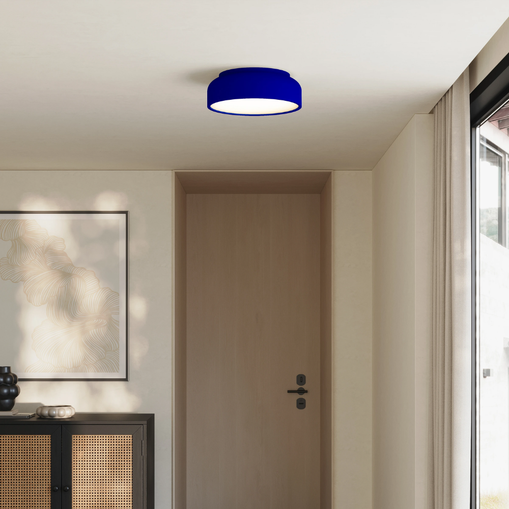 The cobalt Vitria Flush Mount from Gantri in a living room on the ceiling.
