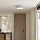 The fog Vitria Flush Mount from Gantri in a living room on the ceiling.