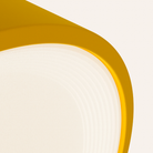 The mustard Vitria Flush Mount from Gantri close up.