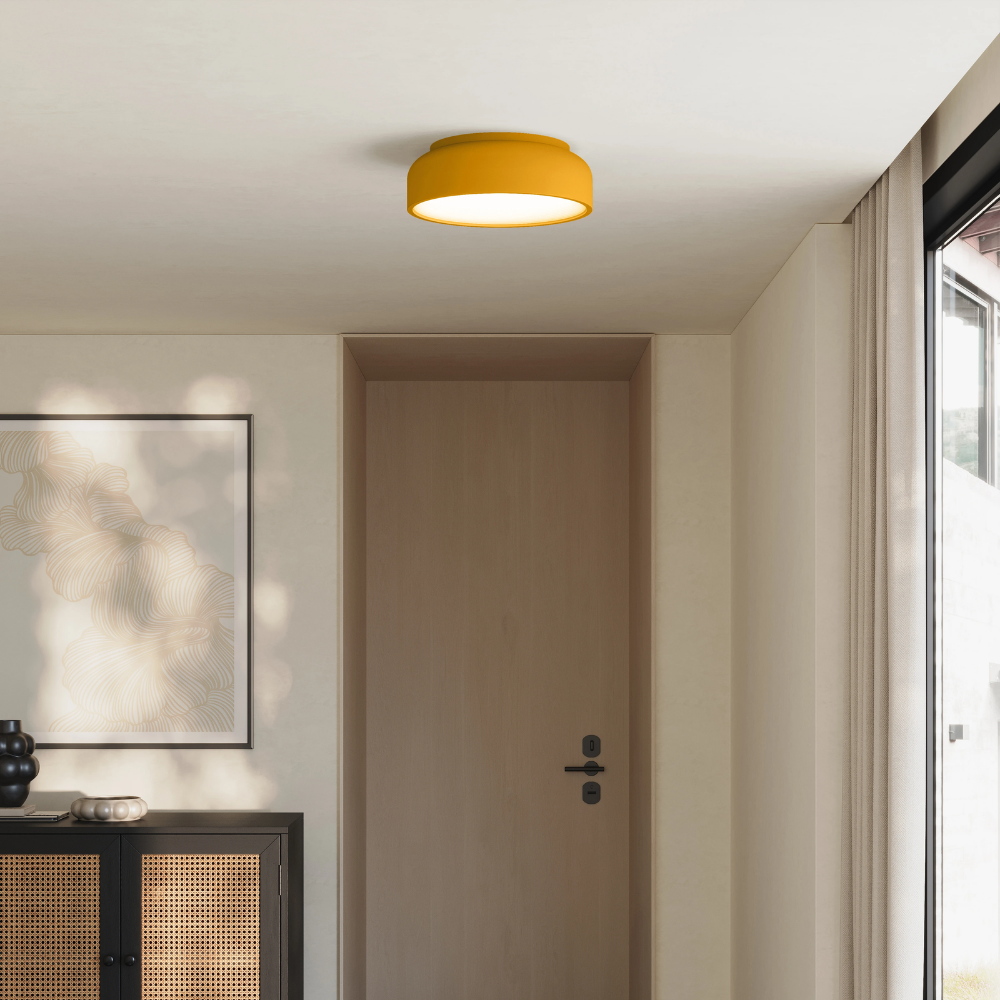 The mustard Vitria Flush Mount from Gantri in a living room on the ceiling.