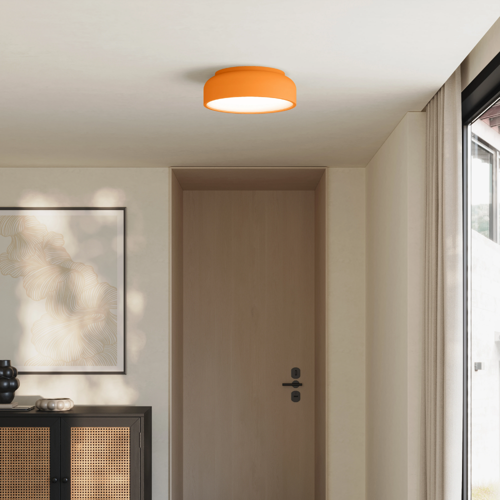 The persimmon Vitria Flush Mount from Gantri in a living room on the ceiling.