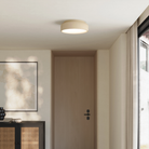 The sand Vitria Flush Mount from Gantri in a living room on the ceiling.