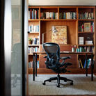 The Aeron Chair from Herman Miller with the adjustable Posturefit SL back support in Nightfall / Nightfall from the rear in a home office.
