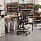 The Aeron Stool from Herman Miller in a business lifestyle photograph inside of a warehouse office.