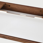 The Airia Desk from Herman Miller with the storage compartment open.