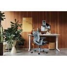 The glacier Cosm Office Chair from Herman Miller in a workspace.