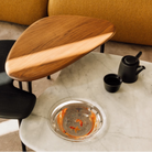 The low carrara marble table with bowl, mid black and high walnut Cyclade Tables from Herman Miller.