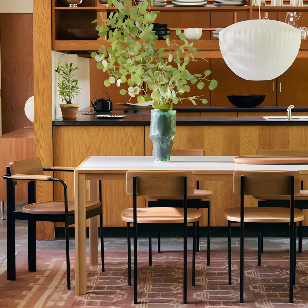 The oak Doubleframe Table from Herman Miller in a family space.