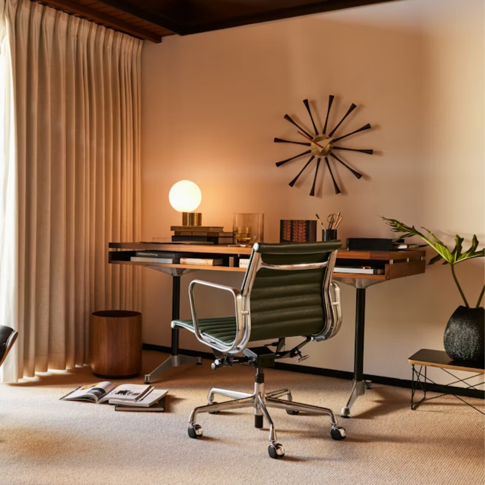 The walnut Eames 2500 Series Executive Desk from Herman Miller in a family area.