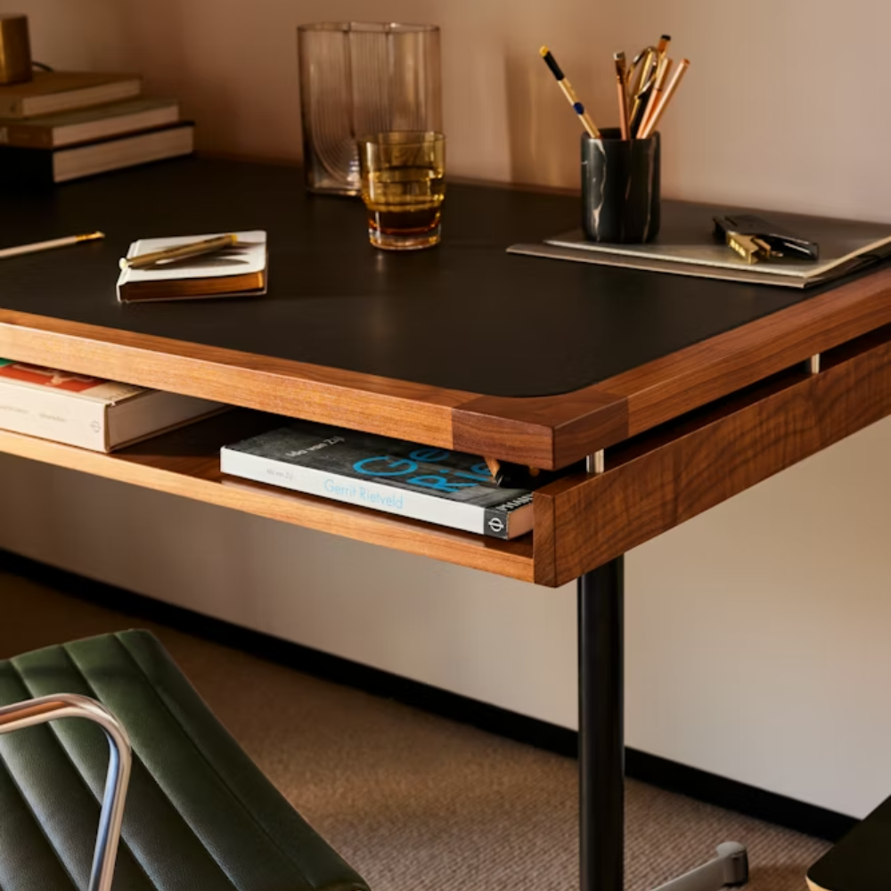The walnut Eames 2500 Series Executive Desk from Herman Miller in a living room.