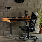 The white oak Eames 2500 Series Executive Desk from Herman Miller in a home office.