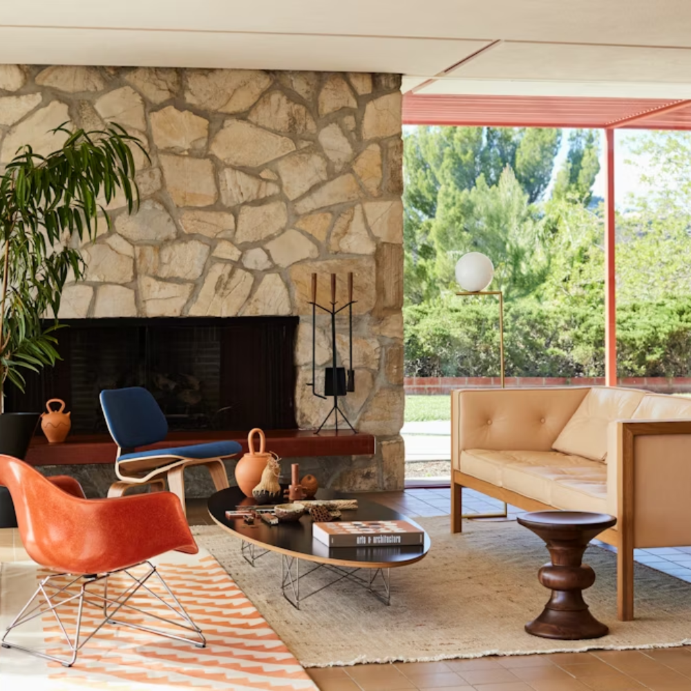 The black Eames Elliptical Table from Herman Miller in a family space. all-groups