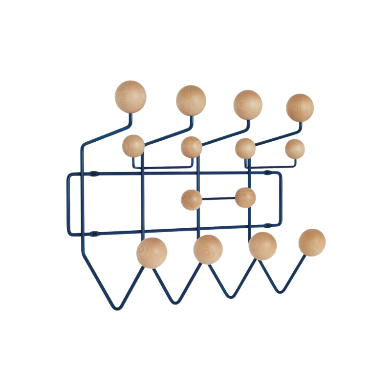 The Eames Hang-It-All, originally released in 1953, exemplifies the Eameses' belief in taking pleasure seriously. Made with a sturdy steel frame and solid wood balls, this colorful coat rack was created using the same technique for simultaneously welding wires that Charles and Ray developed for their low tables and wire chairs.