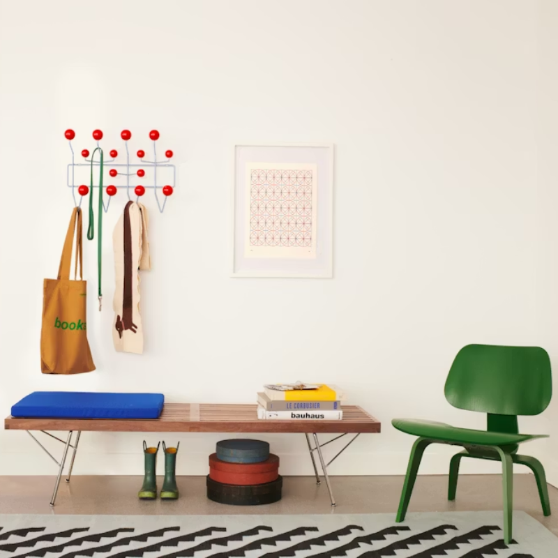 The Eames Hang-It-All  Stonewash Blue Red from Herman Miller in a hall.