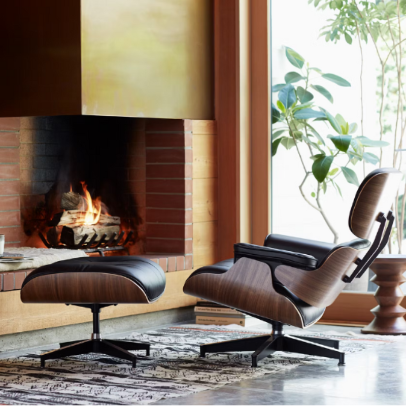 The Eames Lounge Chair and Ottoman from Herman Miller in a cabin beside a fire. all-groups