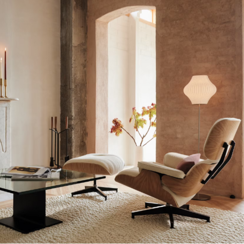 The Eames Lounge Chair and Ottoman from Herman Miller in a room with a fireplace. all-groups
