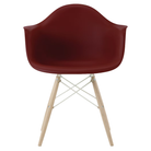 The brick red shell Eames Molded Plastic Armchair Dowel-Leg Base with the white base and white oak legs.
