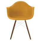 The deep yellow shell Eames Molded Plastic Armchair Dowel-Leg Base with the white base and walnut legs.